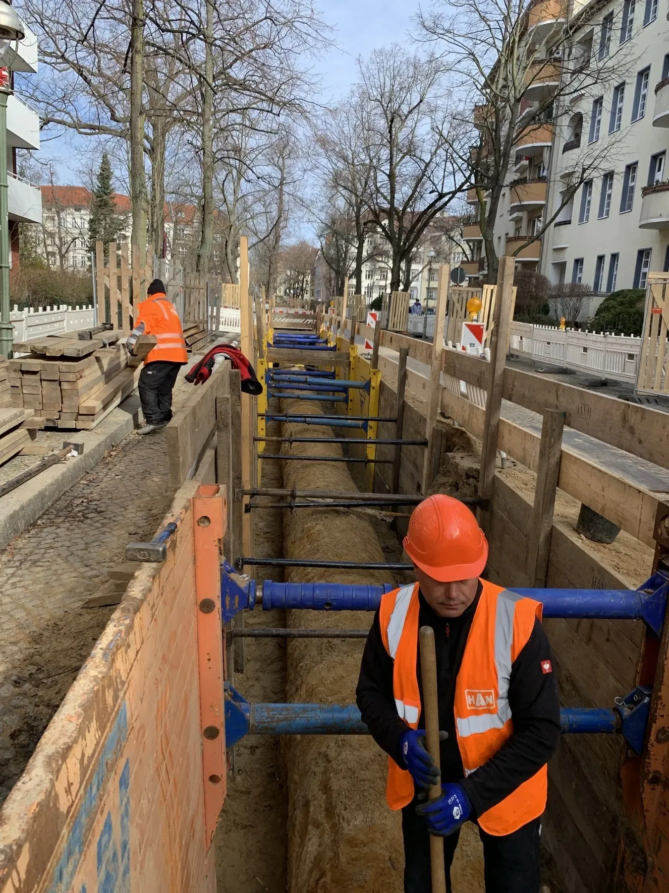 Verbauter Leitungsgraben einer HAN-Baustelle mit verlegten Leitungen
